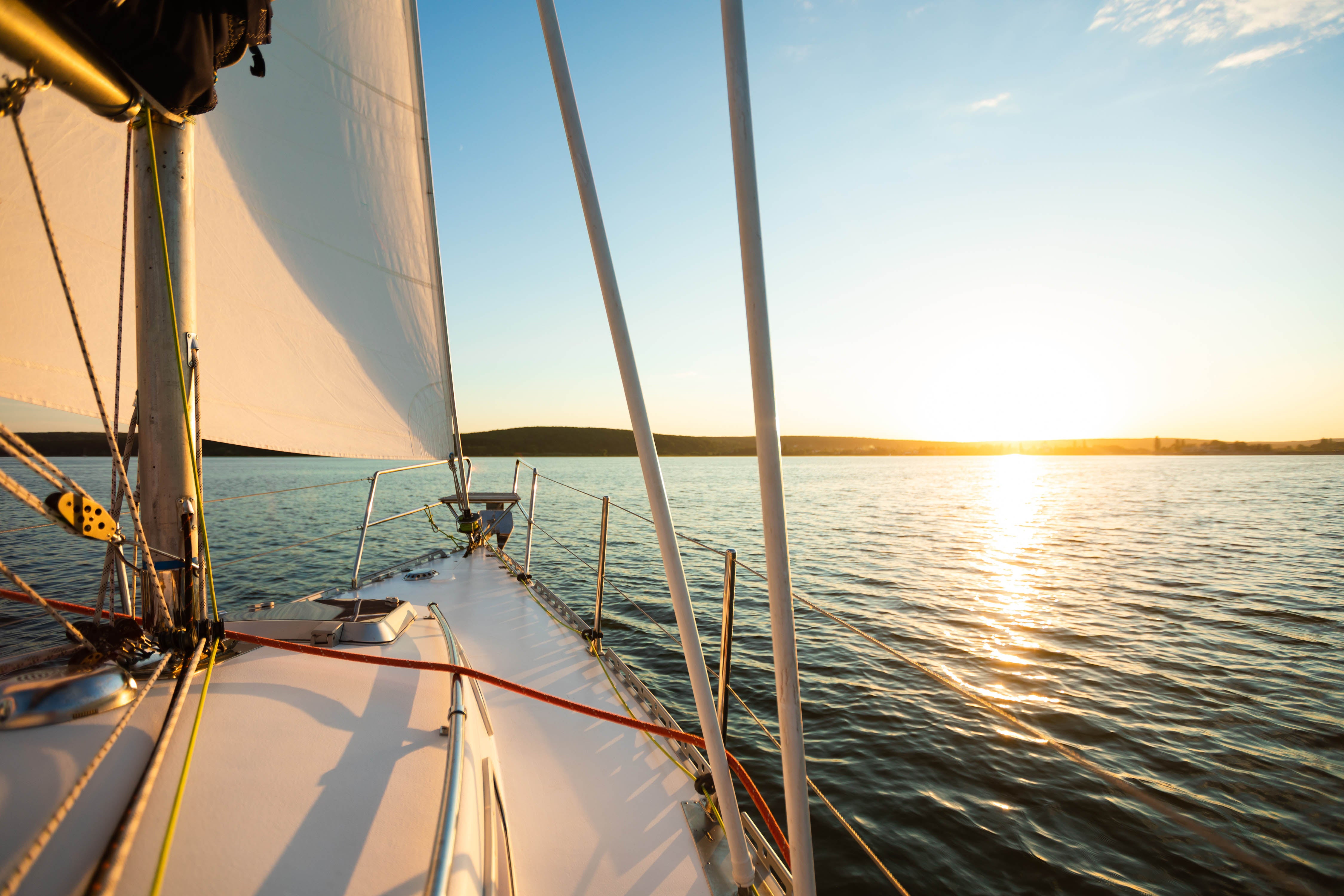 White sailing yacht cruising offshore on a sunny summer day