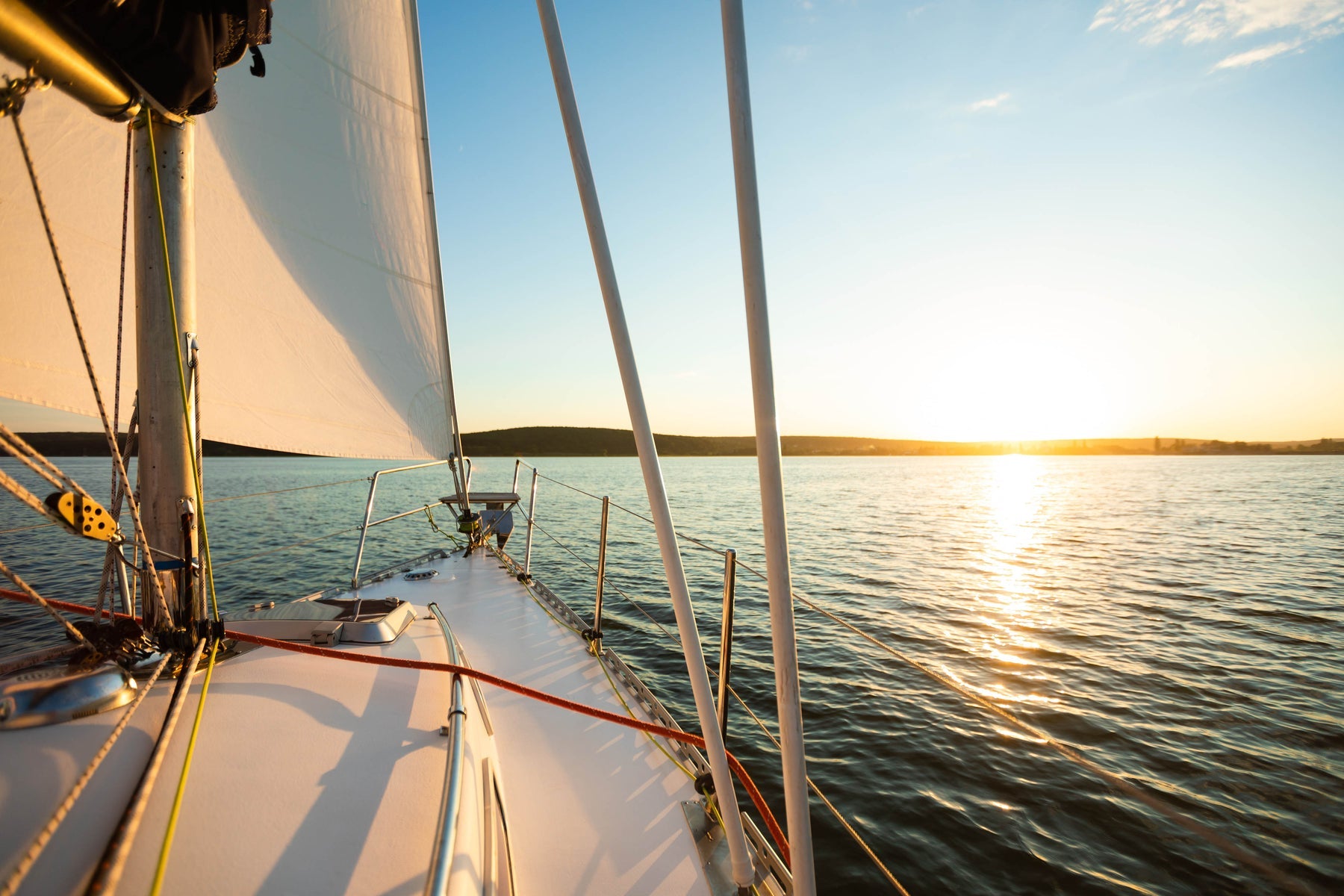 White sailing yacht cruising offshore on a sunny summer day