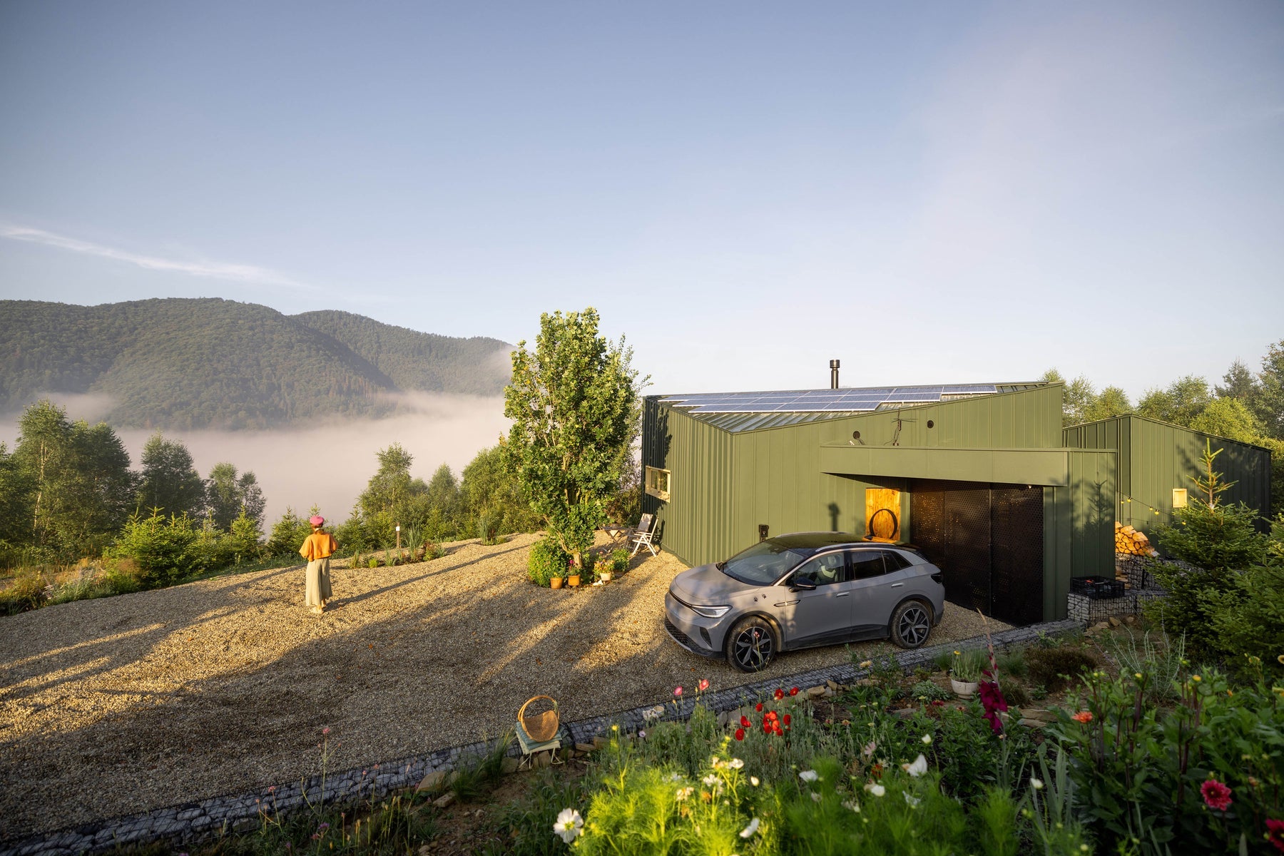 Modern off grid cabin in misty mountains powered by renewable energy